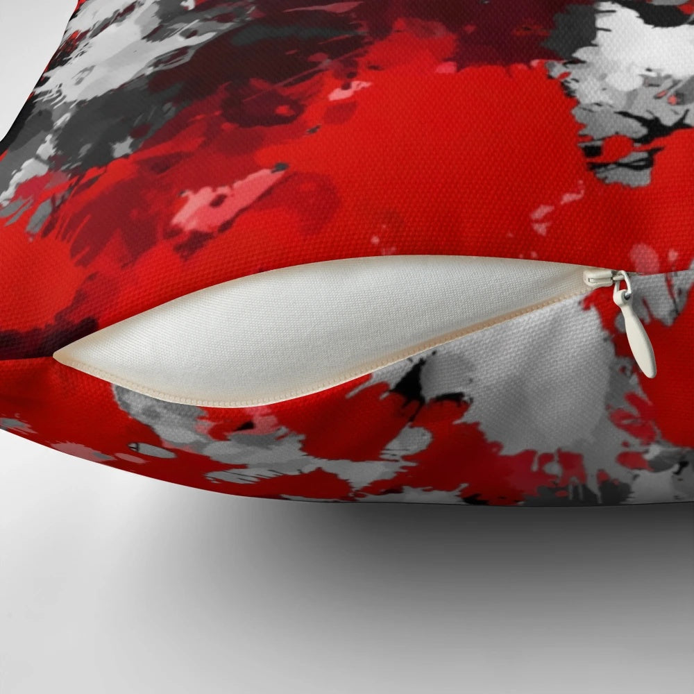 Colorful paint splatter pattern decorative pillow in red, grey, and white