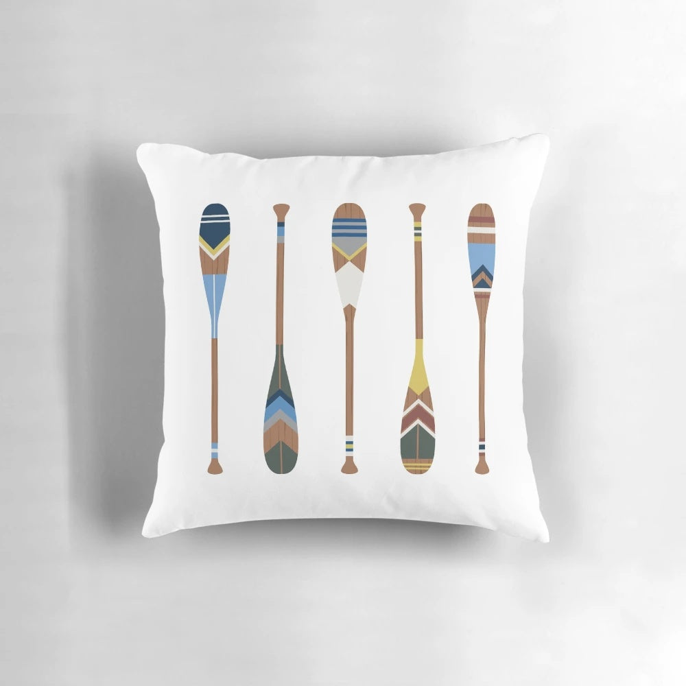 Vibrant decorative pillow featuring a painted oar design, perfect for coastal, boho, and lake house style home decor.