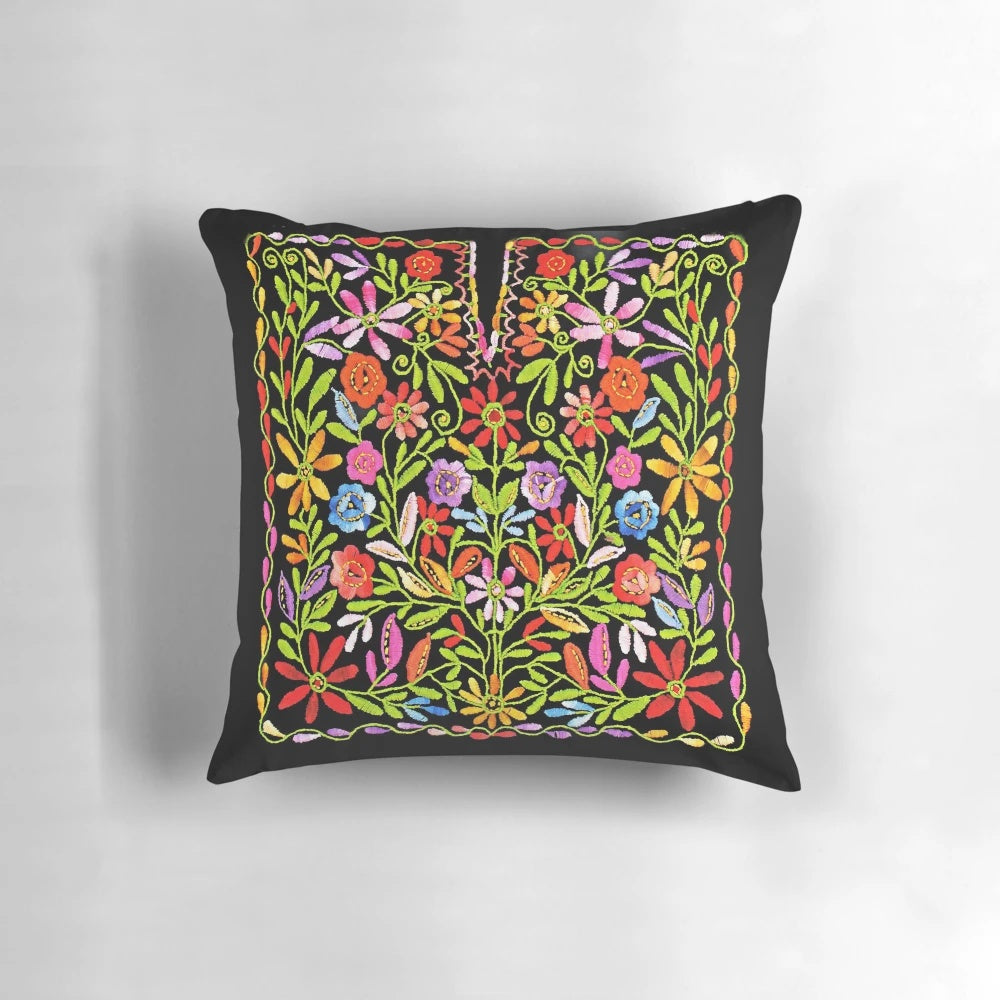 Colorful embroidered pillow featuring traditional Palestinian flowers and patterns