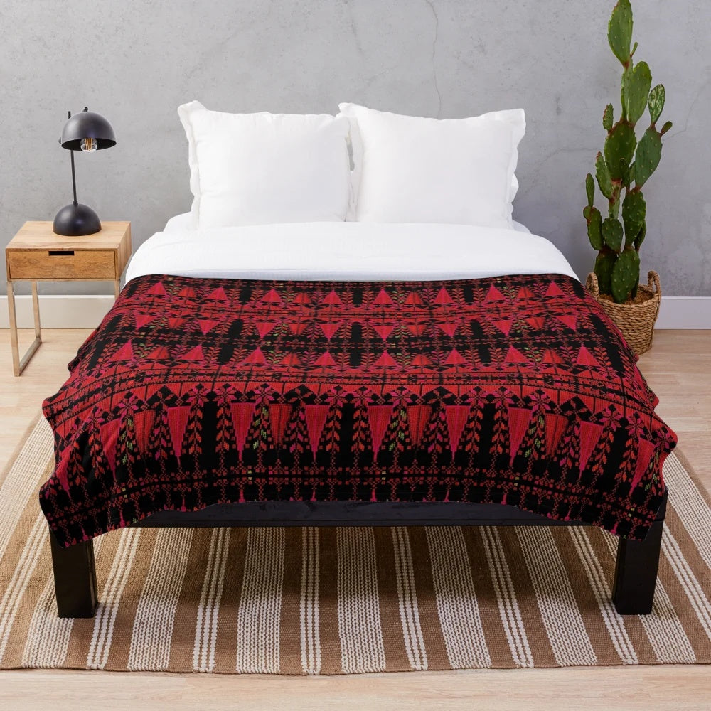 Plush blanket with vibrant Palestinian-inspired red tree design
