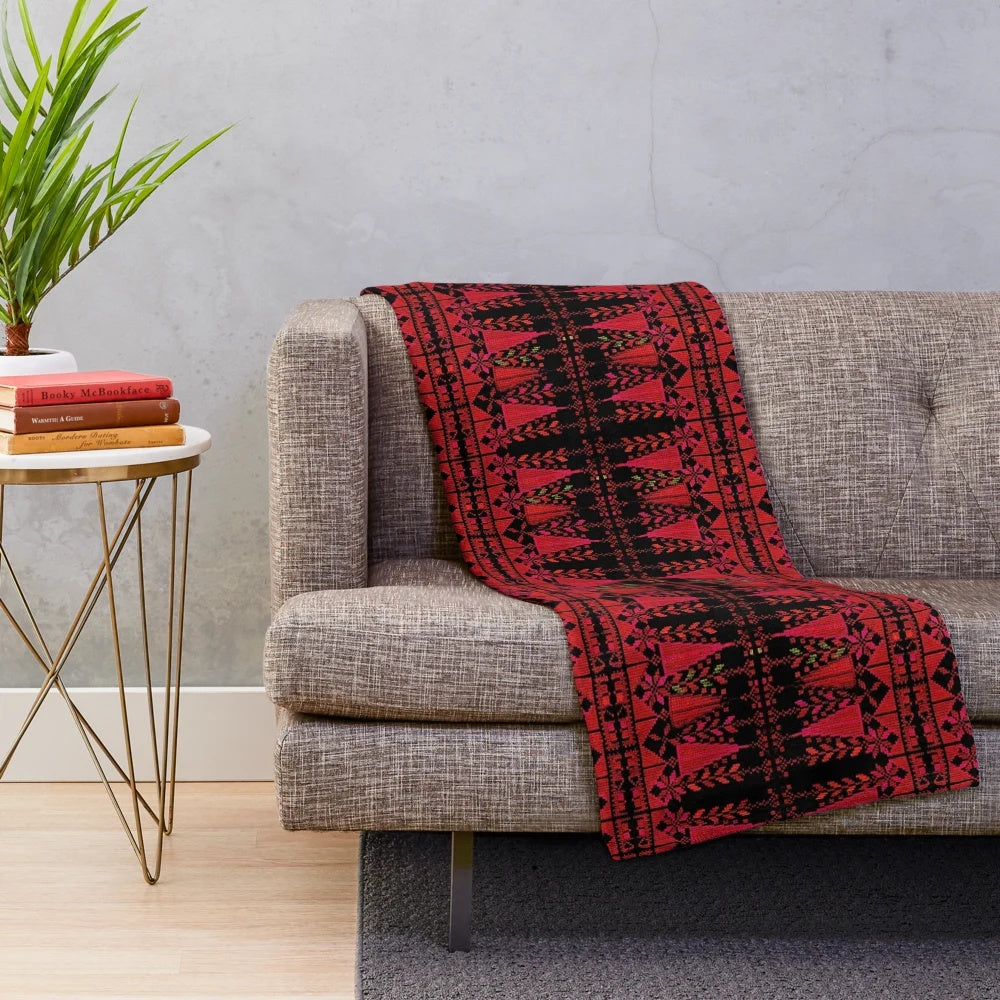 Plush blanket with vibrant Palestinian-inspired red tree design