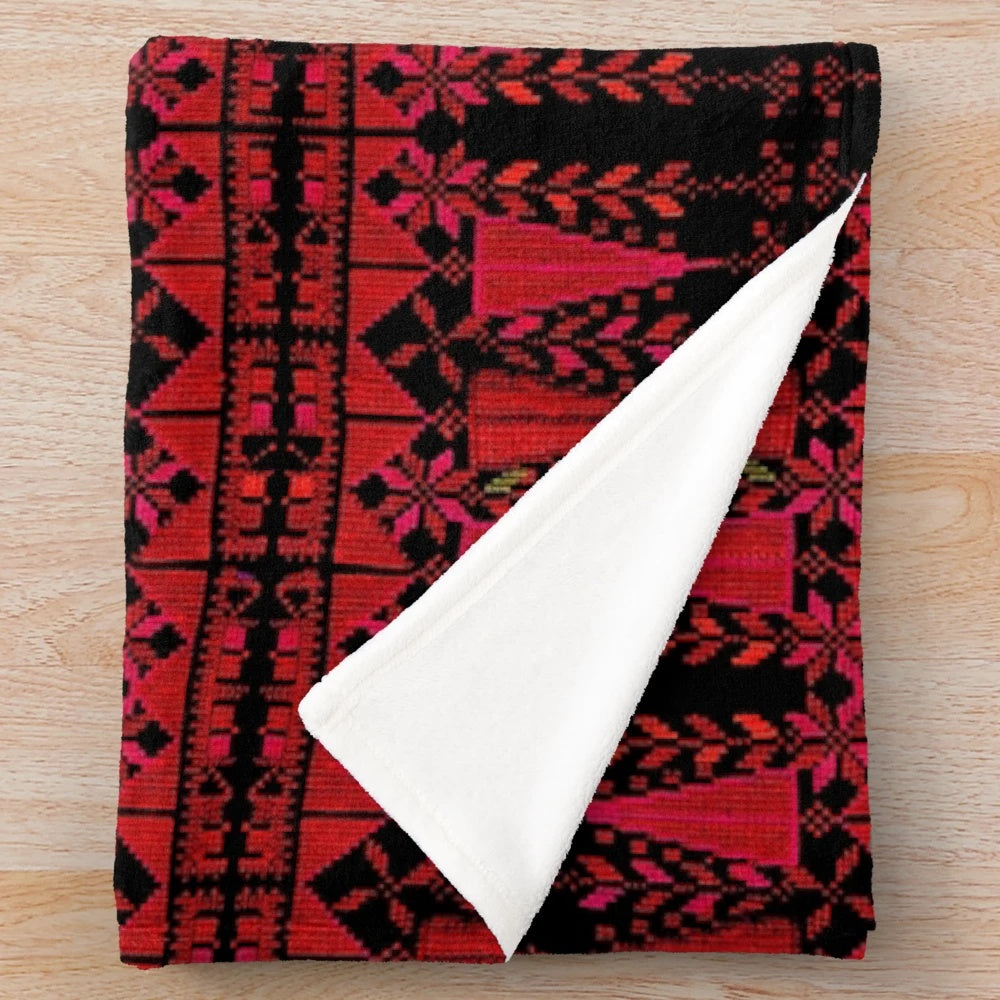 Plush blanket with vibrant Palestinian-inspired red tree design