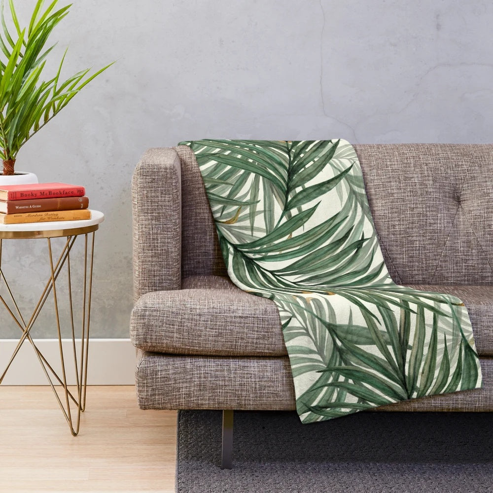 Soft, plush blanket featuring a watercolor palm leaves design in a lush, green color palette