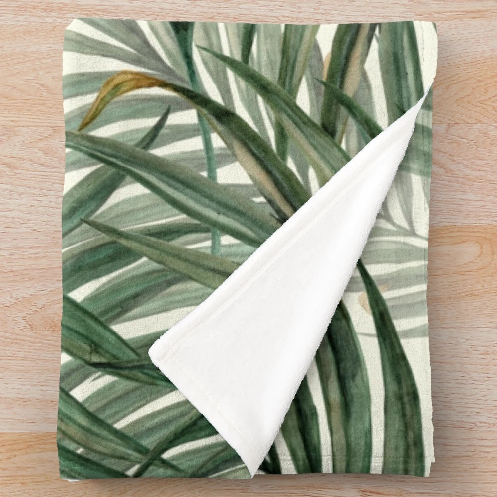 Soft, plush blanket featuring a watercolor palm leaves design in a lush, green color palette