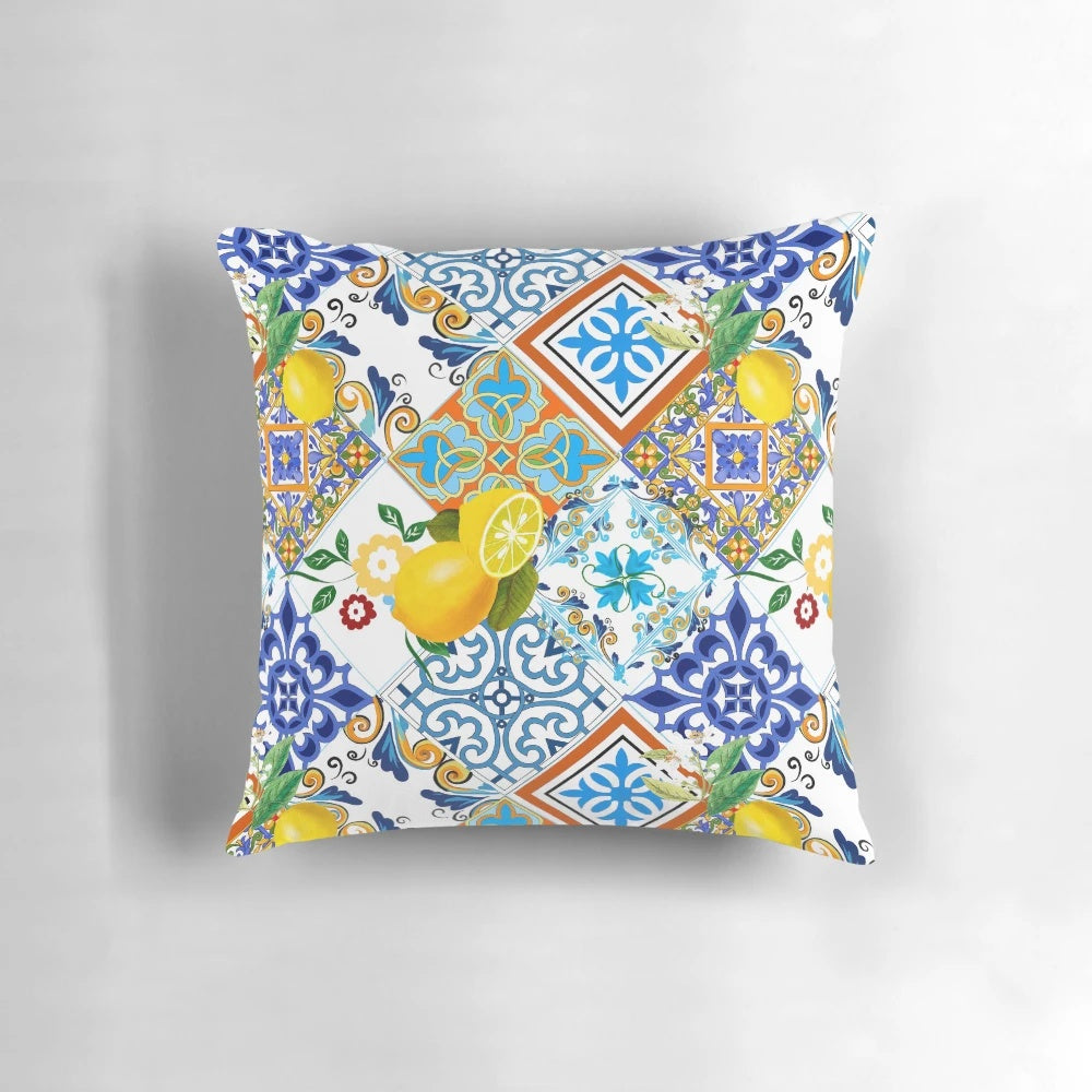 Colorful patchwork pillow featuring a mosaic of azulejo-style Portuguese tiles and vibrant citrus and lemon motifs.