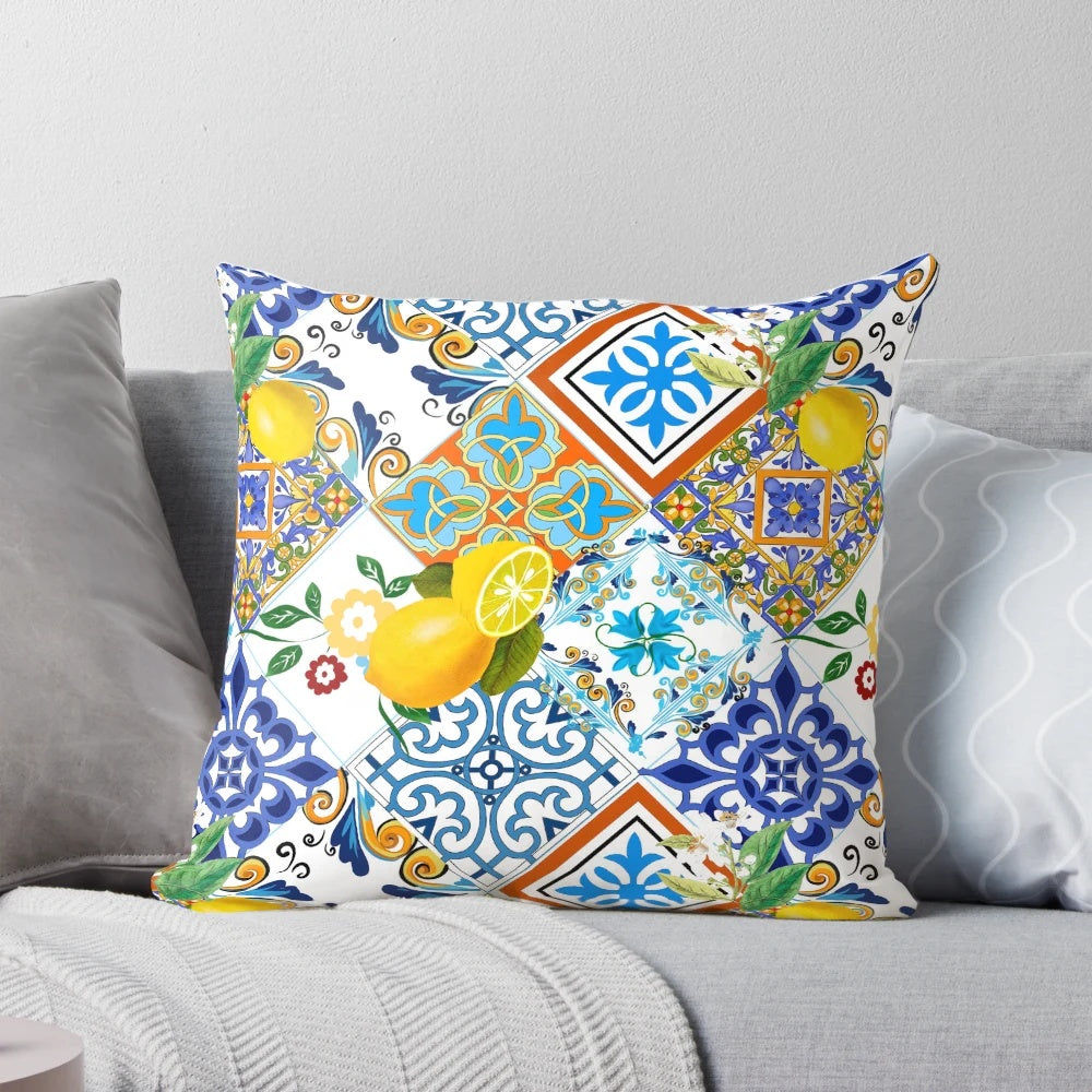 Colorful patchwork pillow featuring a mosaic of azulejo-style Portuguese tiles and vibrant citrus and lemon motifs.