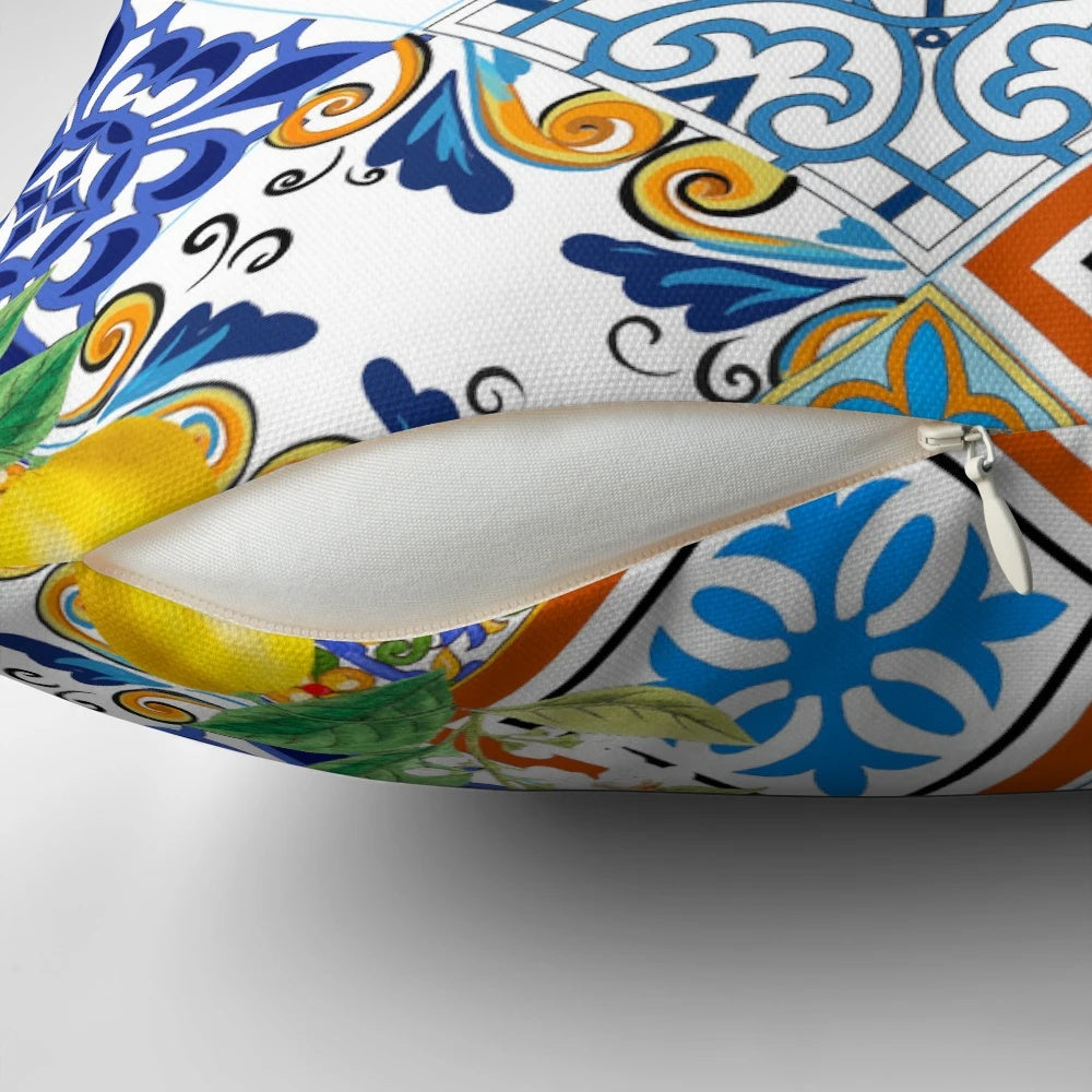 Colorful patchwork pillow featuring a mosaic of azulejo-style Portuguese tiles and vibrant citrus and lemon motifs.