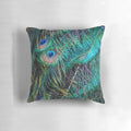 Vibrant and luminous peacock feather pillow with shimmering green, purple, and blue hues