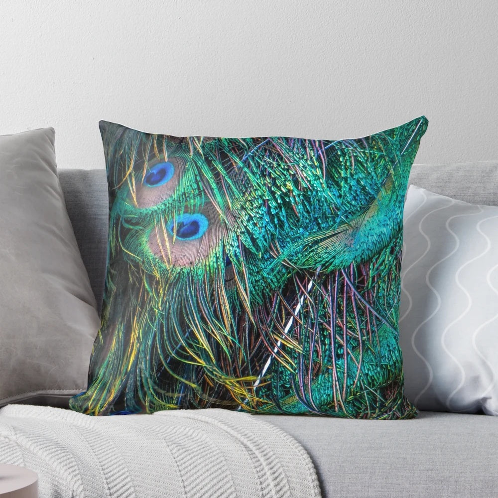 Vibrant and luminous peacock feather pillow with shimmering green, purple, and blue hues
