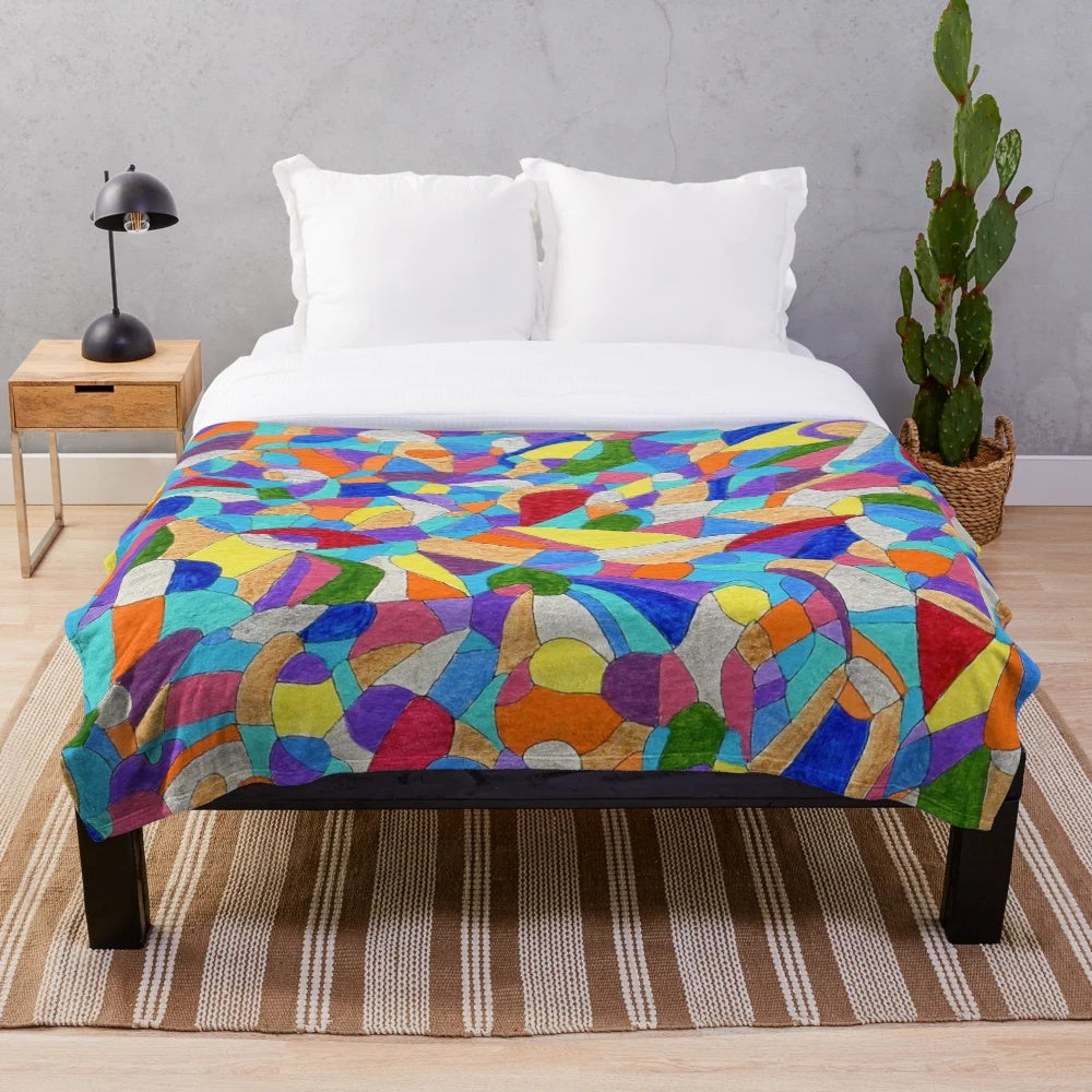 Colorful plush blanket featuring pebble patterns and abstract floral designs