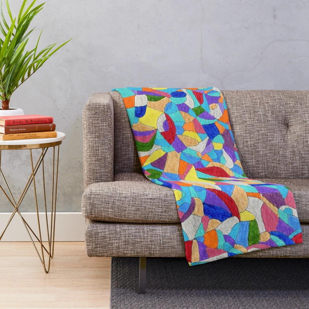Colorful plush blanket featuring pebble patterns and abstract floral designs
