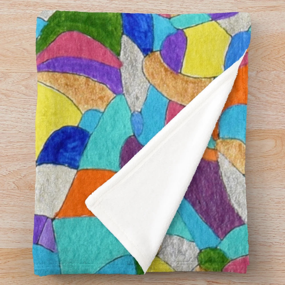 Colorful plush blanket featuring pebble patterns and abstract floral designs