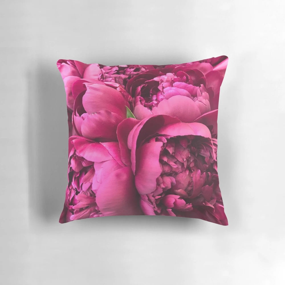 Colorful hot pink peony flowers on a decorative throw pillow
