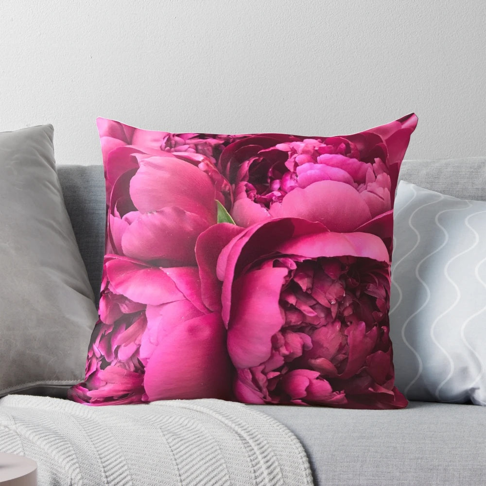 Colorful hot pink peony flowers on a decorative throw pillow