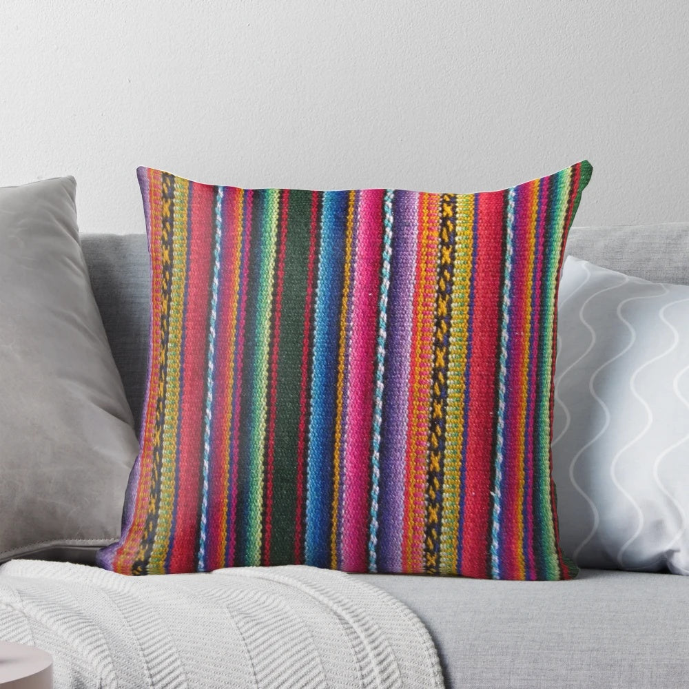 Colorful striped and patterned decorative pillow in Peruvian textile style