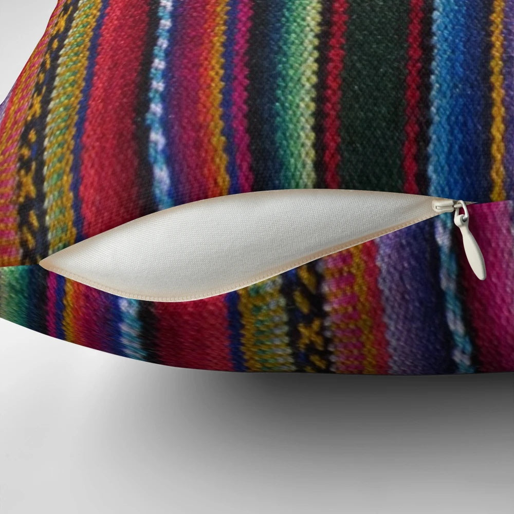 Colorful striped and patterned decorative pillow in Peruvian textile style