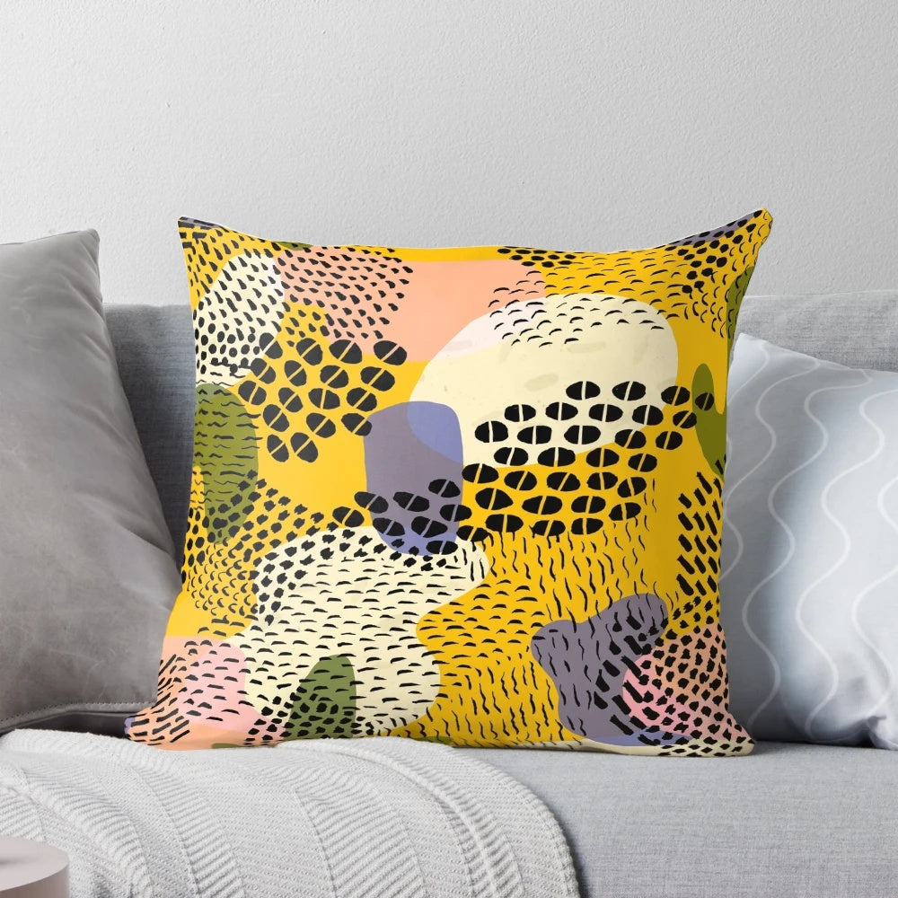 Colorful pina colada-inspired pillow with abstract geometric patterns of dots, circles, and lines in yellow, green, and purple