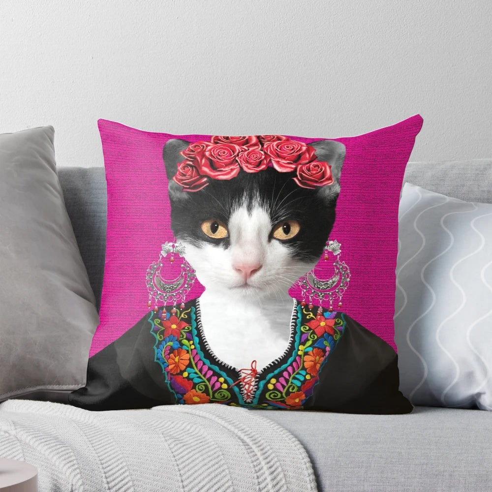 A pink and floral decorative pillow featuring a playful black cat, inspired by the iconic artwork of Mexican artist Frida Kahlo.