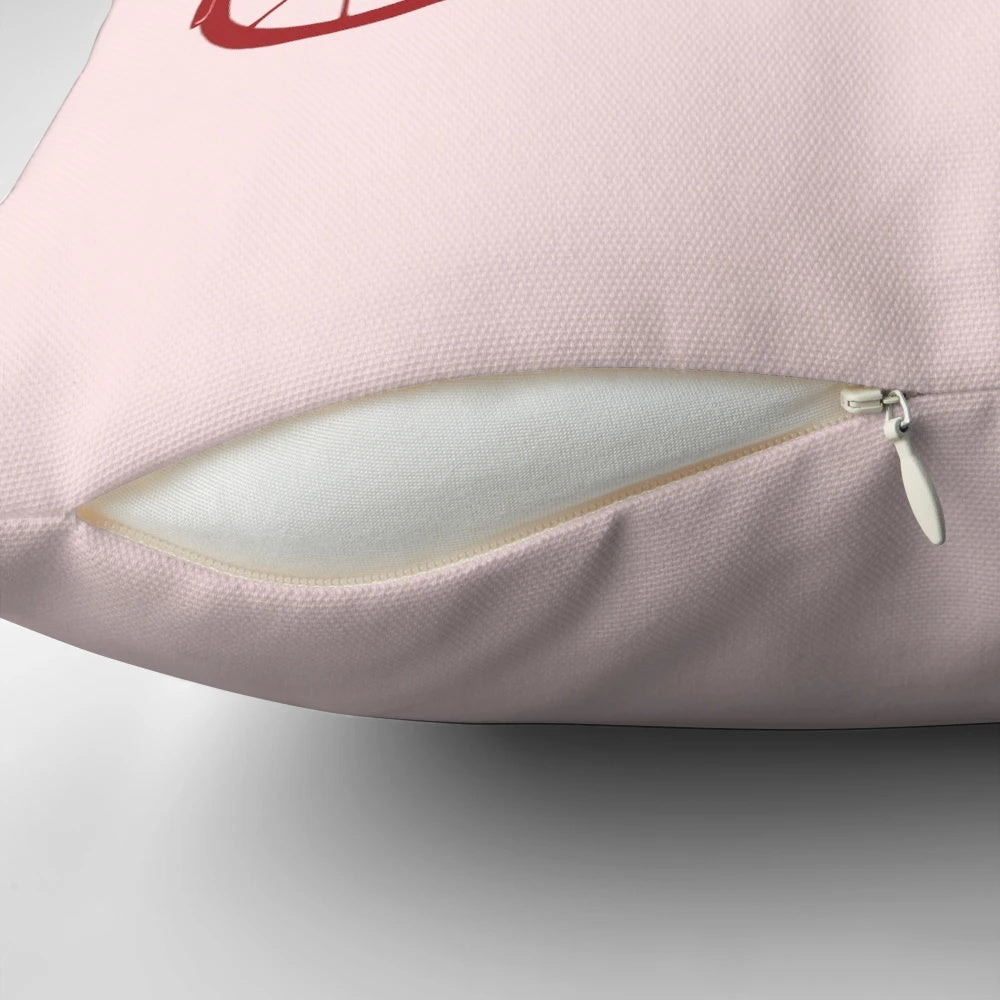 Colorful pink flamingos riding a tandem bicycle on a decorative pillow