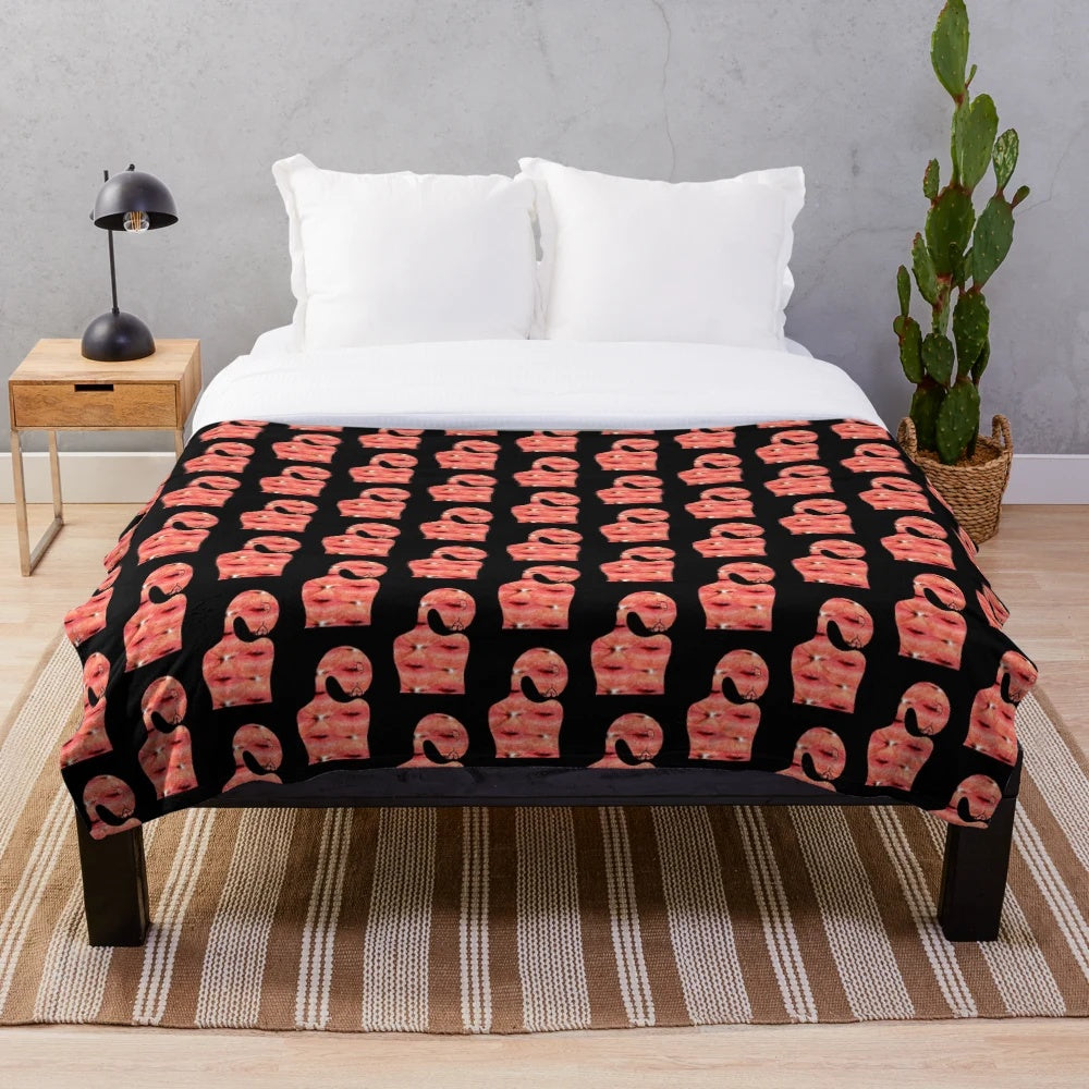 Soft and cozy pink plush blanket with a vibrant pop art inspired pattern