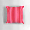 Bright pink and red striped throw pillow with modern, vertical lines