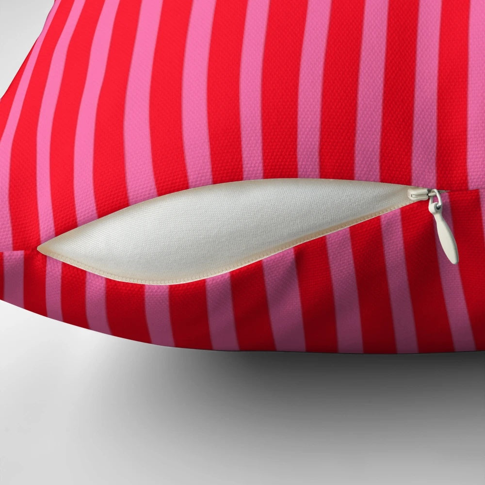 Bright pink and red striped throw pillow with modern, vertical lines