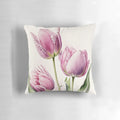 A soft, decorative throw pillow featuring a vibrant pink tulips floral design.