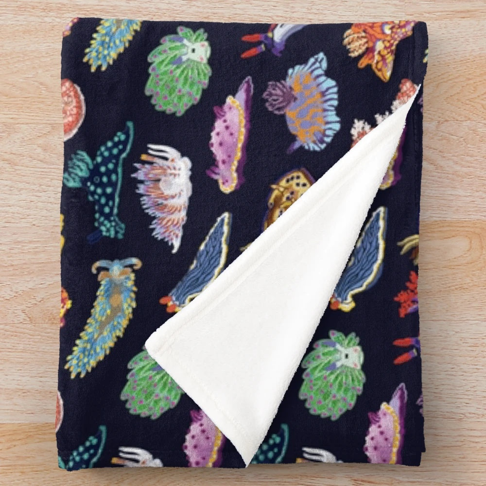Colorful plush blanket with detailed sea slug/nudibranch design