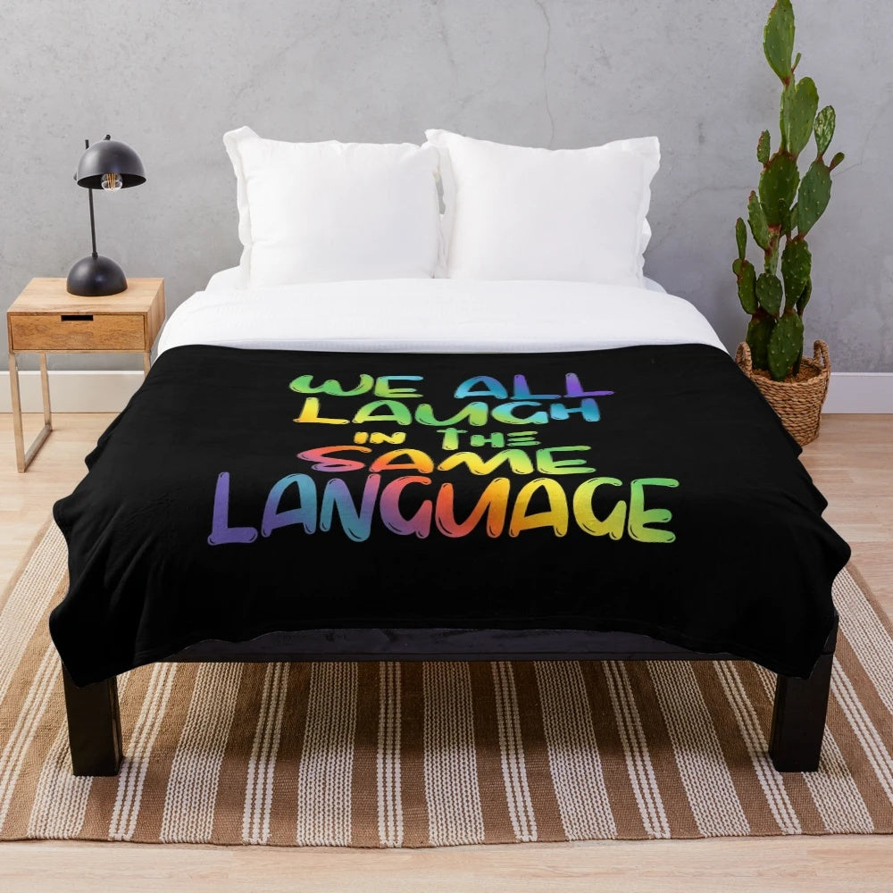 Colorful plush blanket with the quote "We All Laugh in the Same Language" for ESL and ESOL teachers