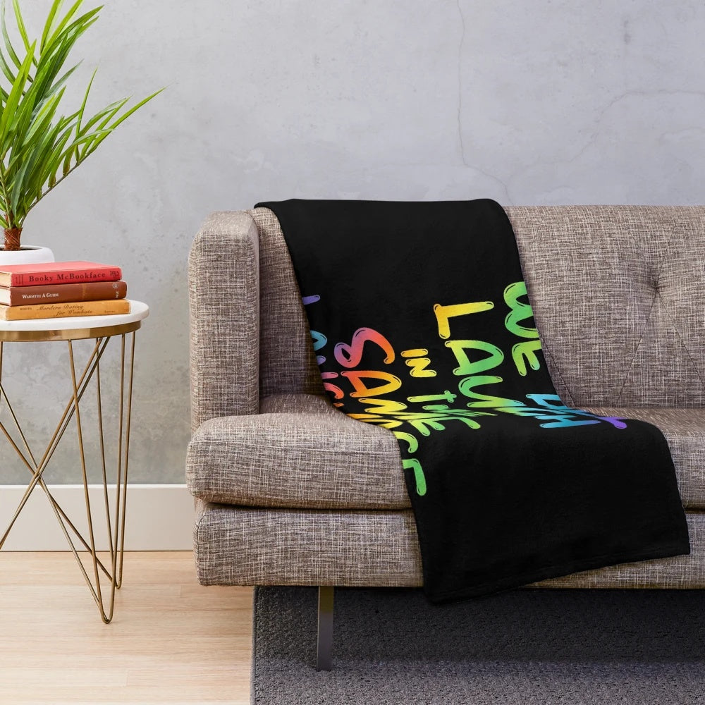 Colorful plush blanket with the quote "We All Laugh in the Same Language" for ESL and ESOL teachers