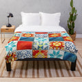 Colorful plush blanket featuring an abstract mosaic design inspired by azulejo tiles from the Azul board game