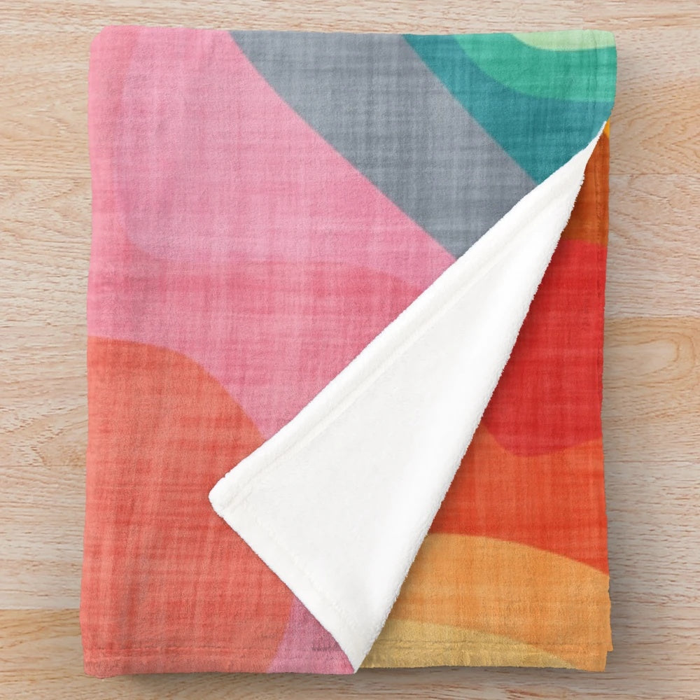 Colorful plush blanket with abstract rainbow pattern