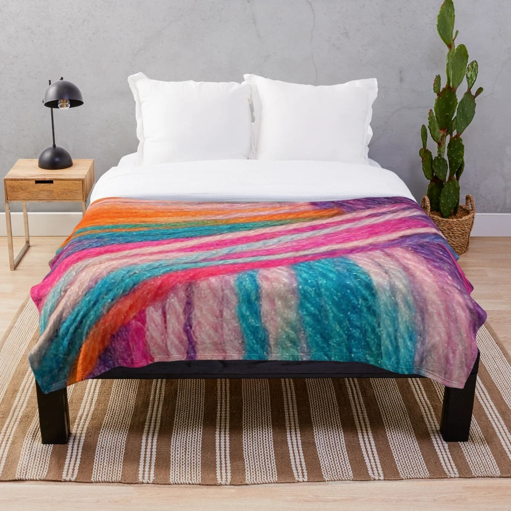 Colorful plush blanket made with bright yarn for crochet and knitting hobbyists