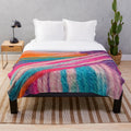 Colorful plush blanket made with bright yarn for crochet and knitting hobbyists