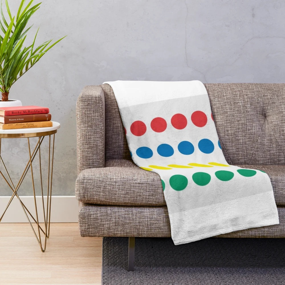 Colorful plush blanket with retro game-inspired polka dot and primary color pattern
