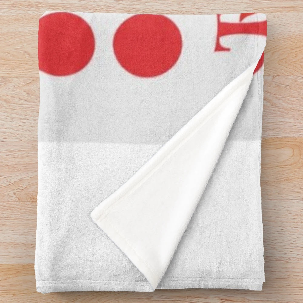 Colorful plush blanket with retro game-inspired polka dot and primary color pattern