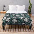 Vibrant plush blanket featuring a watercolor pattern of laughing elephants