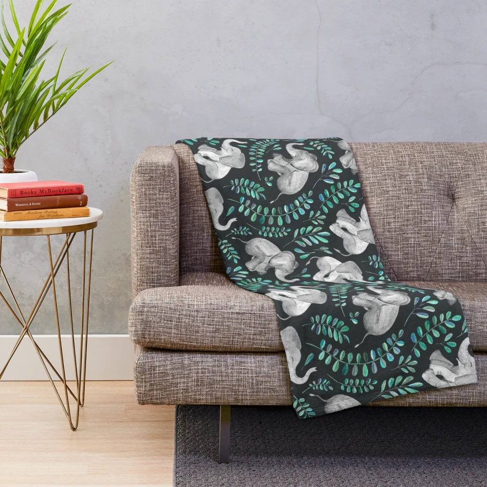 Vibrant plush blanket featuring a watercolor pattern of laughing elephants