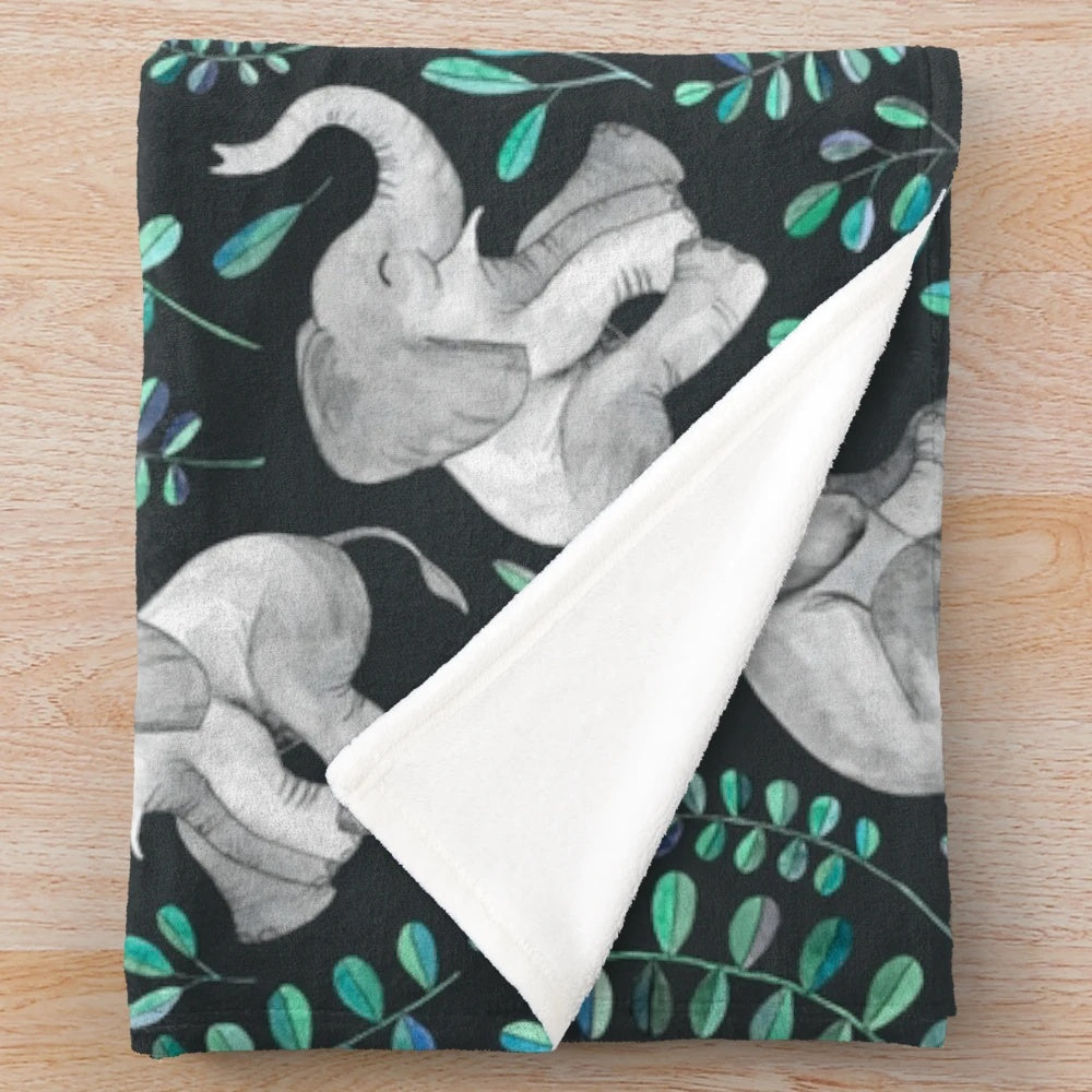 Vibrant plush blanket featuring a watercolor pattern of laughing elephants