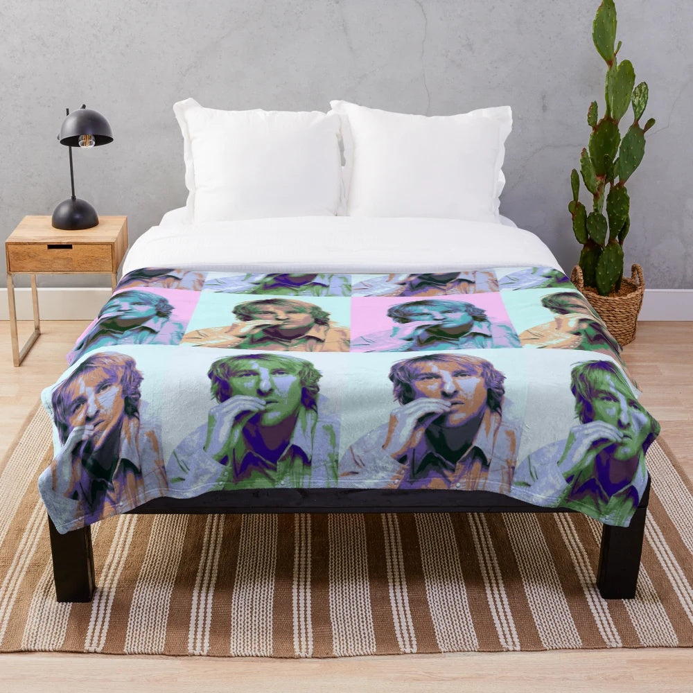 Colorful pop art-style portrait of actor Owen Wilson on a plush blanket