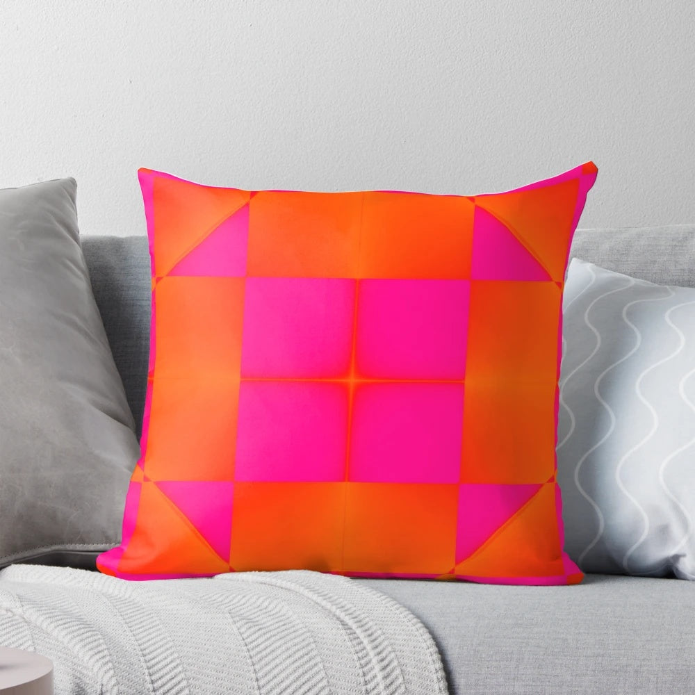 Vibrant pink and orange graphic pillow with squares and triangles
