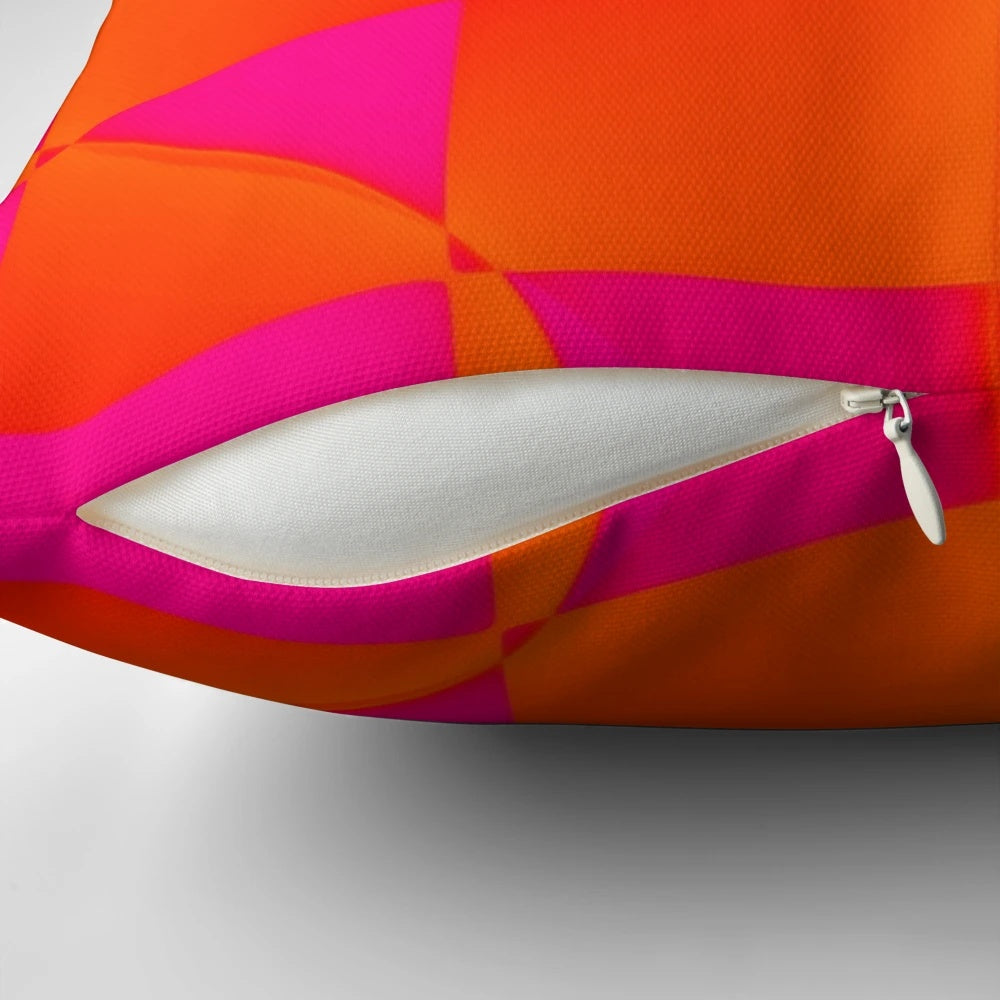Vibrant pink and orange graphic pillow with squares and triangles
