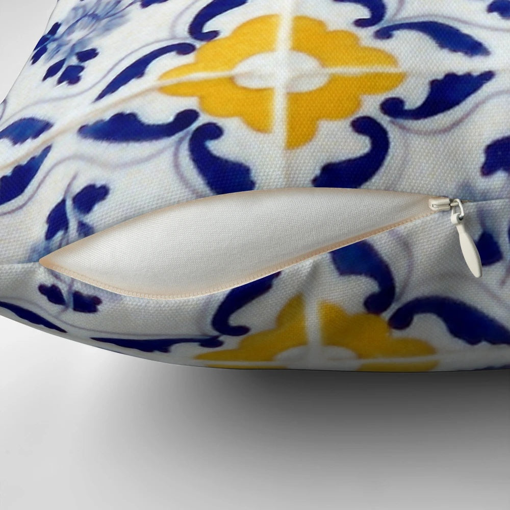 A pillow featuring a colorful pattern of blue and yellow Portuguese-inspired tiles.