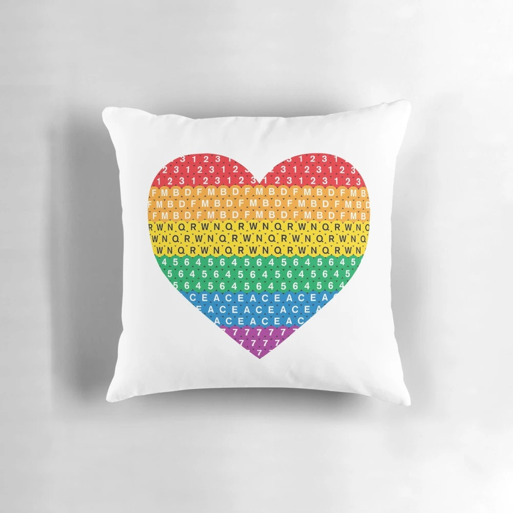 Colorful throw pillow with Pride flag design and heart shape, perfect for LGBTQ home decor
