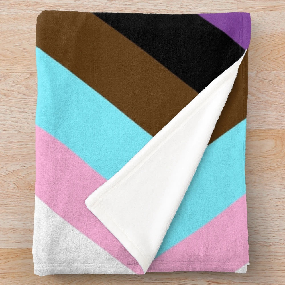 Plush blanket in the colors of the progress pride flag, representing LGBTQIA+ diversity and inclusion.