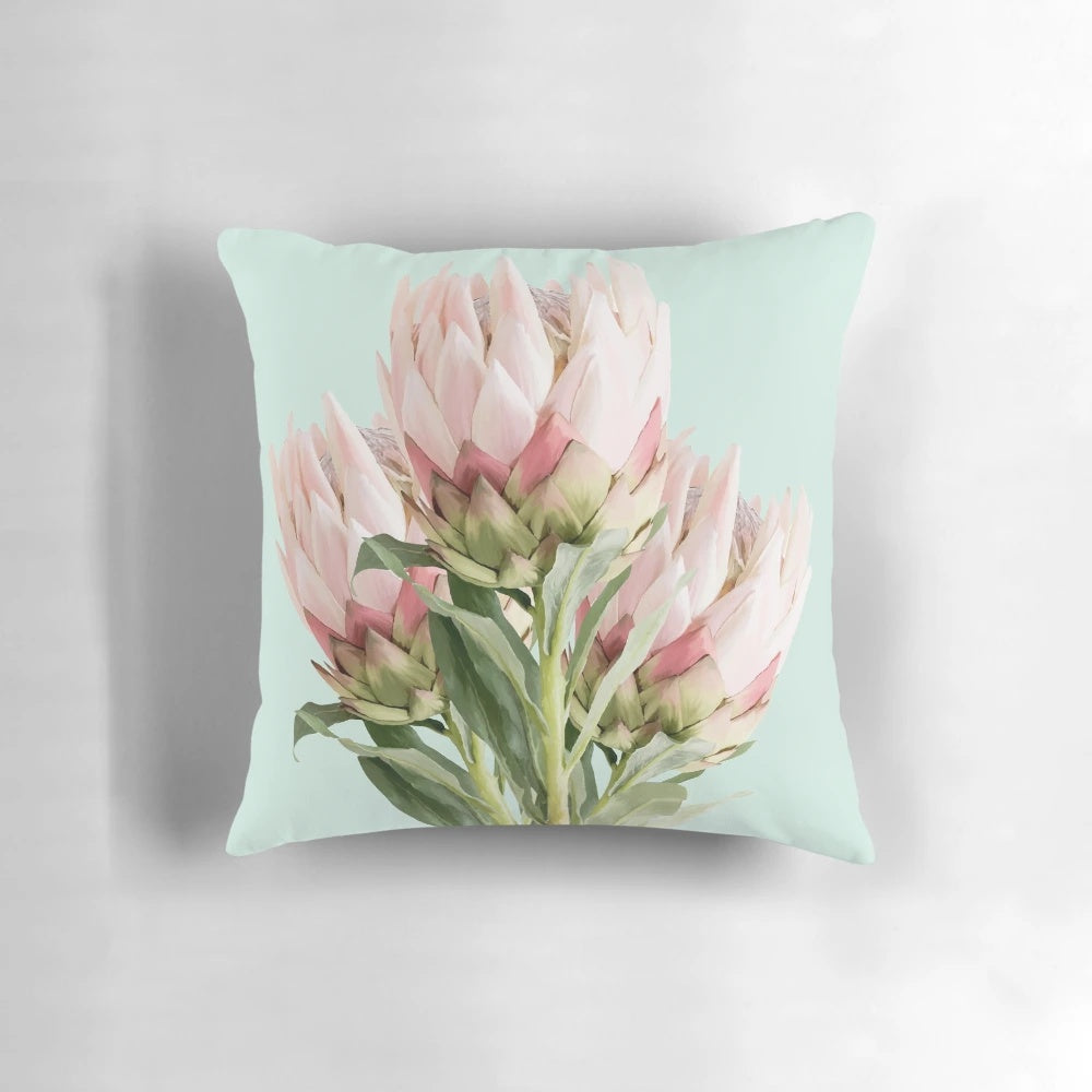 Colorful protea flowers printed on a decorative throw pillow