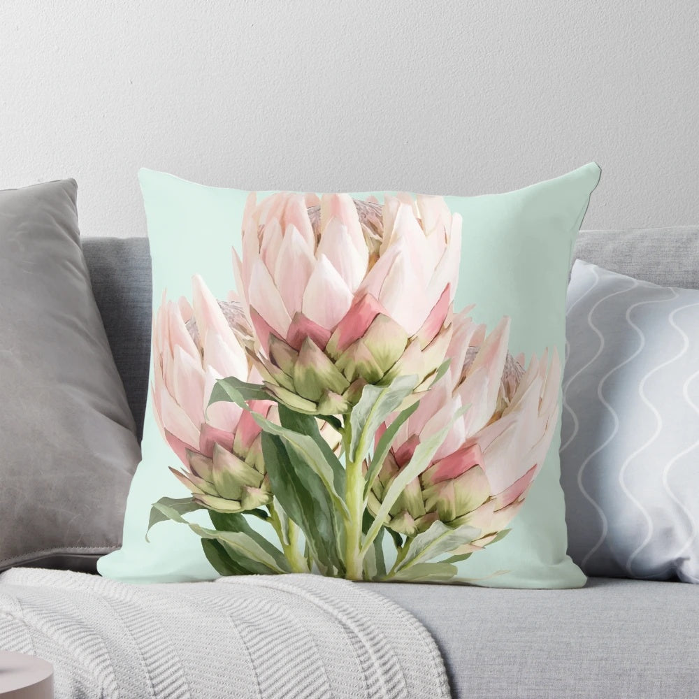 Colorful protea flowers printed on a decorative throw pillow