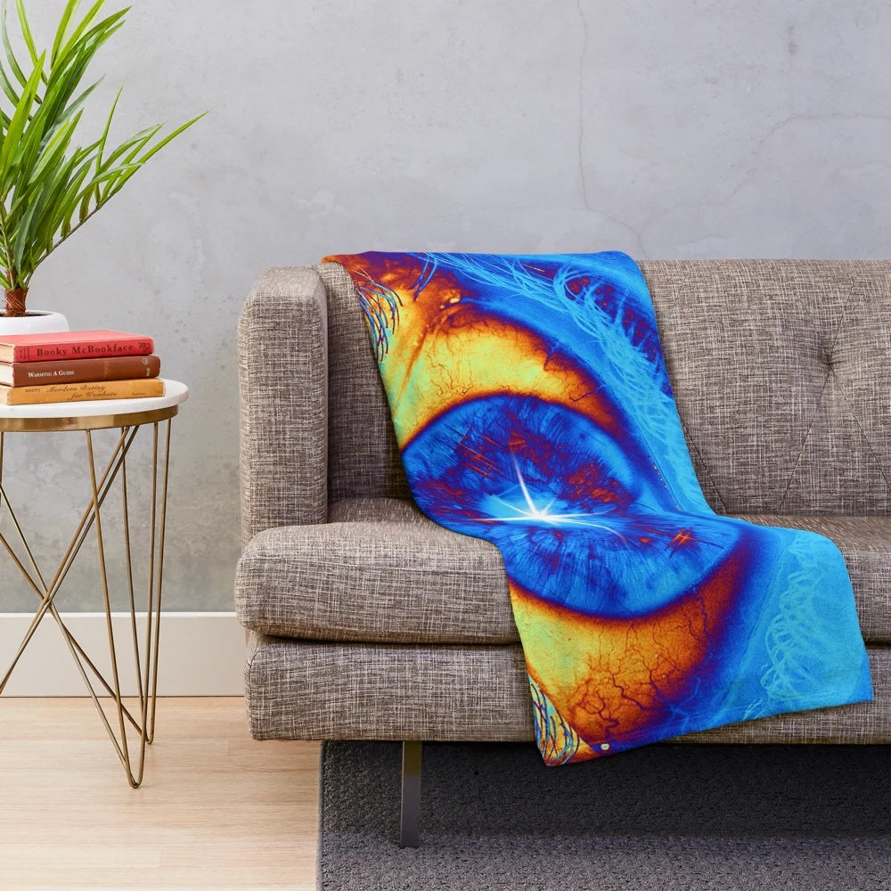 Psychedelic eye-shaped plush blanket with vibrant, abstract design