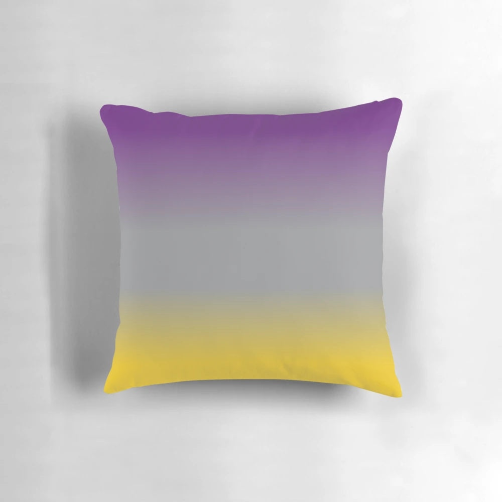 A plush, decorative throw pillow featuring a gradient design in shades of purple, grey, and yellow.