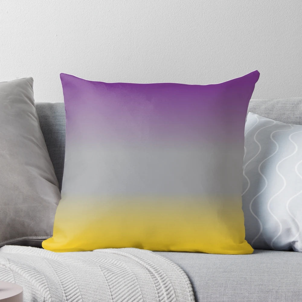A plush, decorative throw pillow featuring a gradient design in shades of purple, grey, and yellow.